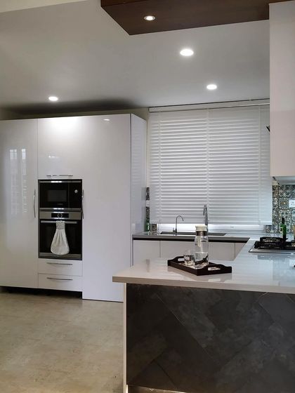 A timeless all-white kitchen we designed six years ago. This space proves that good design endures, with its glossy white cabinets, integrated appliances, and functional breakfast counter looking as fresh and modern today as the day it was installed.