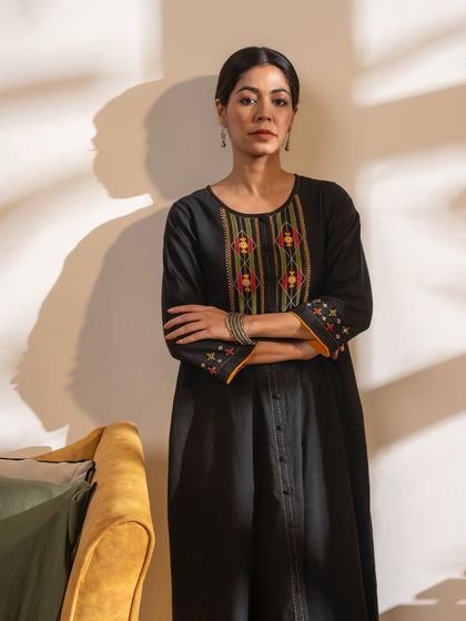 The Paheli black A-line kurta is a timeless piece featuring vibrant Pakka hand embroidery. It’s a perfect example of an elevated basic that can be dressed up or down.