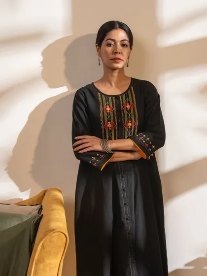 The Paheli black A-line kurta is a timeless piece featuring vibrant Pakka hand embroidery. It’s a perfect example of an elevated basic that can be dressed up or down.
