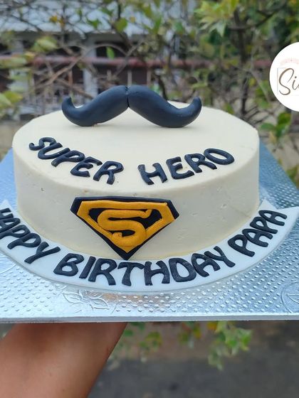 A "Super Hero Papa" cake for a dad's birthday. This simple but sweet design features a mustache and a Superman-style "S" logo.