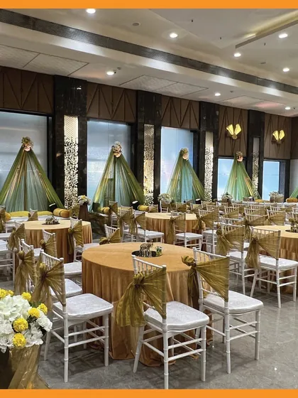 A wide view of the Mehendi hall, showcasing the coordinated guest seating and the elegant, draped backdrops for different function areas.
