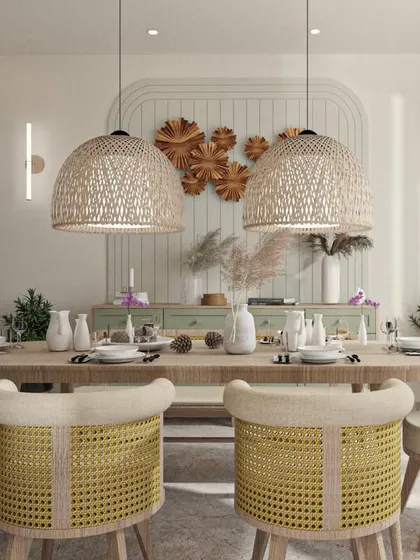 A Japandi-style dining room with woven pendant lights, cane-back chairs, and a simple wooden table.