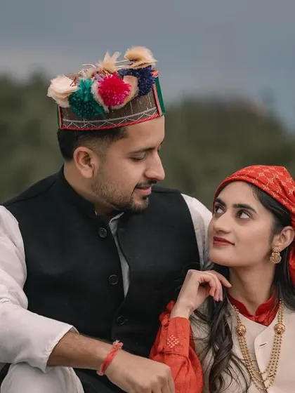A beautiful portrait of a couple in traditional Himachali attire, celebrating their heritage amidst the natural beauty of the mountains. This is what I call authentic 'Pahari love'.