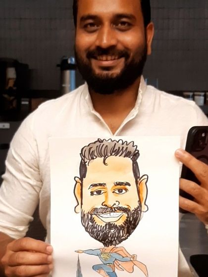 A happy employee from a Google Cloud event holding his custom Superman-themed caricature. These personalized drawings make for fantastic and memorable corporate gifts.