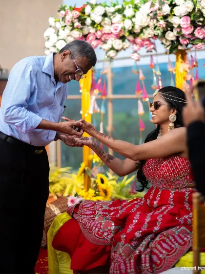 A touching moment between the bride and her father during the Mehendi ceremony. These family interactions are priceless.