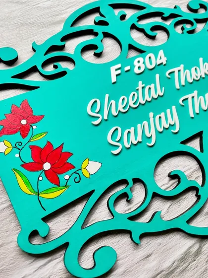 The elegant script and detailed craftsmanship on this custom wooden nameplate make it a standout piece for any home.