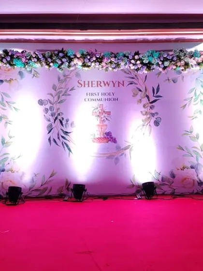 A clean and elegant stage for Sherwyn's First Holy Communion. The setup features a personalized backdrop with his name, beautiful floral arrangements, and professional lighting to make the moment feel truly special and blessed.