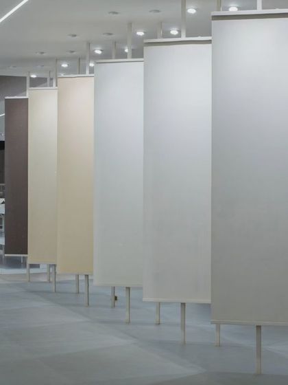 More images from the Krsimar marble showroom, detailing the sliding panel display system and the clean, spacious layout designed for an optimal client experience.