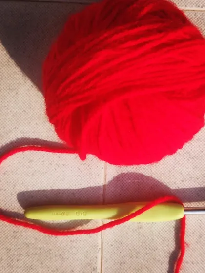 How did I turn this simple ball of red yarn into a beautiful finished piece? It's all magic. Stay tuned to see the final reveal.