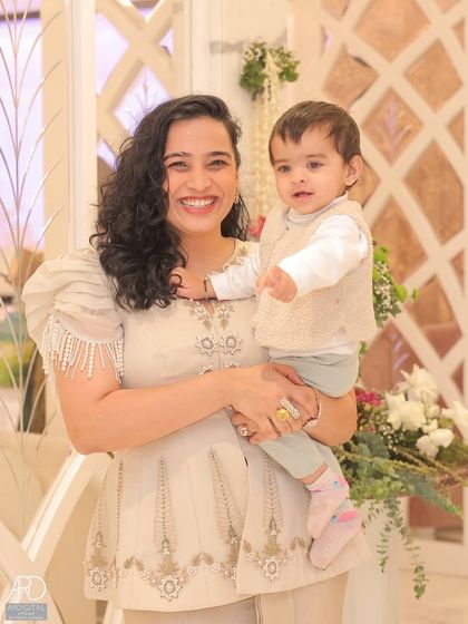 A beautiful portrait of me and Gauri at a housewarming event I was hosting. This image combines my role as a mother and a professional anchor, showing I can create content even while working.