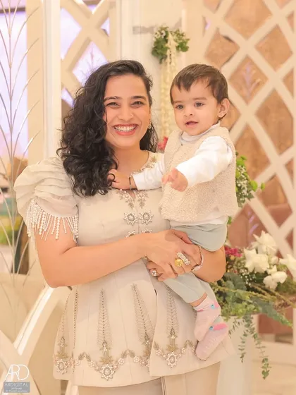 A beautiful portrait of me and Gauri at a housewarming event I was hosting. This image combines my role as a mother and a professional anchor, showing I can create content even while working.