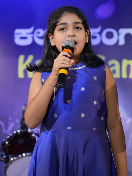 A close up of a young vocalist, Pranathi Kumar, during her patriotic song performance. Our stage setup ensures every performer gets their moment in the spotlight.
