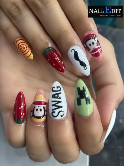 A fun, mismatched set showcasing a variety of hand-painted icons. From Minecraft and strawberries to quirky characters and the word 'SWAG', this design proves that your nails can be a canvas for anything you can imagine.