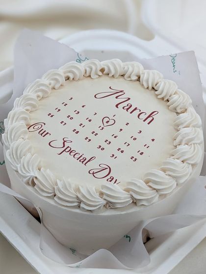 The calendar bento cake in a classic white design with red lettering, perfect for a minimalist and elegant romantic gift.