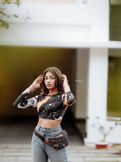 This image showcases a confident and stylish pose. It's a great example of a straightforward fashion portrait that highlights the model's look.