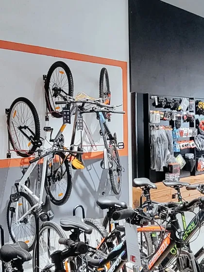 Wall-mounted racks are a space-efficient solution for displaying bicycles. This setup keeps the floor clear and creates an organized, grid-like visual that is easy for customers to browse.