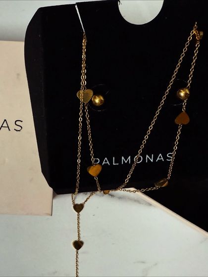 The Palmonas heart necklace displayed in its branded box, emphasizing the quality and presentation of the jewelry.