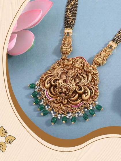 This temple jewellery mangalsutra pendant features an ornate carving of a deity, accented with green beads. It's a piece that beautifully merges sacred symbolism with marital tradition.