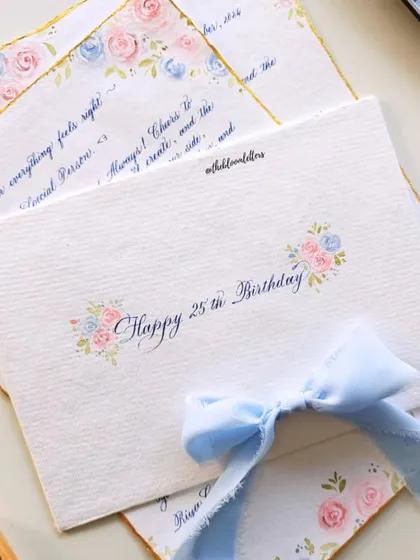 The back of the hand-painted envelope, with "Happy 25th Birthday" written in calligraphy, surrounded by small floral details.