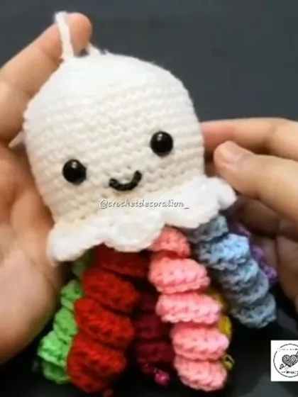This happy little jellyfish features a white head and vibrant, rainbow-colored tentacles. It's a sensory-friendly toy that's soft to the touch and visually engaging for babies and toddlers.