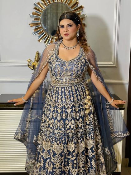 A full-length shot that captures the grandeur of her reception outfit.