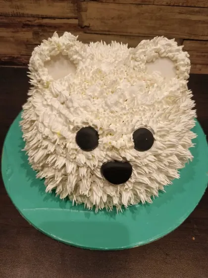 A fluffy and adorable 3D teddy bear face cake. We use piped buttercream to create a realistic fur texture, making this sculpted cake a wonderfully cute choice for a birthday or baby shower.