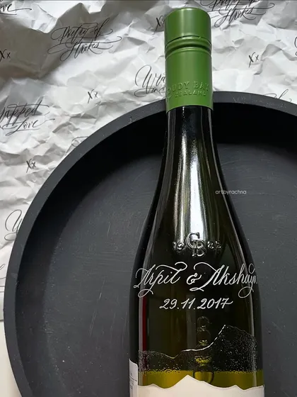 This engraved wine bottle is displayed against a backdrop of my calligraphy, showing how my different art forms complement each other.