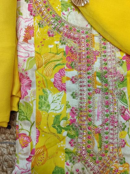 Another option in sunny yellow, this cotton suit piece has a different embroidery pattern on the neckline and comes with a plain yellow dupatta.