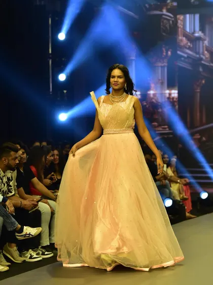 This model showcases the beautiful movement of the Rose Pink gown on the runway. It's designed to be both visually stunning and comfortable to wear.