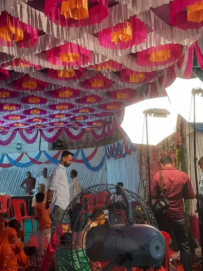 A behind the scenes shot showing the placement of lighting and fans at a large pandal event. Proper placement of equipment is key to a successful event.
