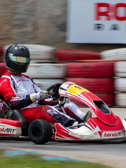 Our driver speeds past the Rotax Racing banner, a common sight at the championships where our team consistently performs at the highest level.