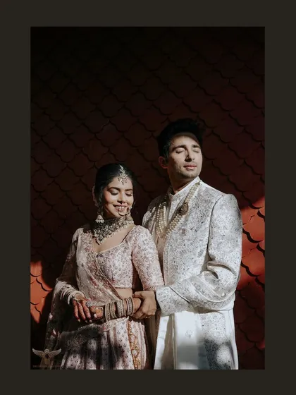 We are chasers of that perfect light. Here, the golden hour sun casts dramatic shadows, highlighting the couple's serene connection and the intricate details of their wedding attire in a shot that feels like a page from a magazine.