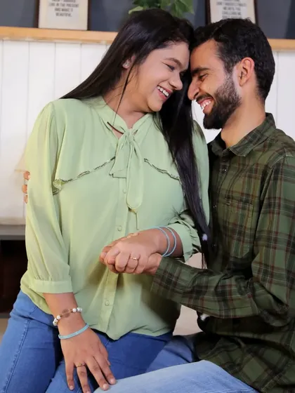 A happy, candid moment from a pre-wedding shoot with a casual theme. The makeup is simple and elegant, focusing on clean skin and a natural glow.