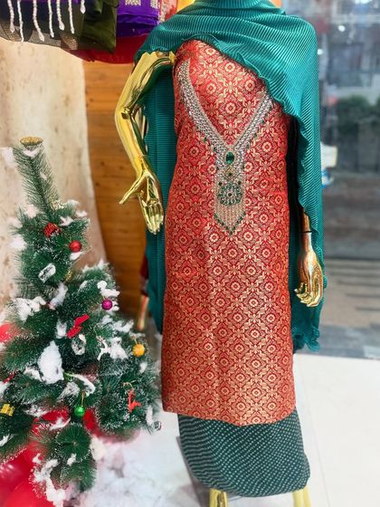 An 'Ishq wala suit'. This red Banarasi suit with a contrasting green dupatta is a classic combination for the festive season.