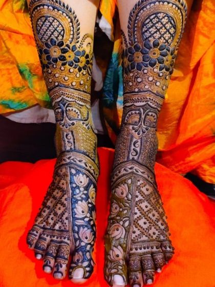 A colorful and intricate full-foot design where blue and yellow accents are used to highlight the floral and geometric patterns, offering a unique, modern twist.