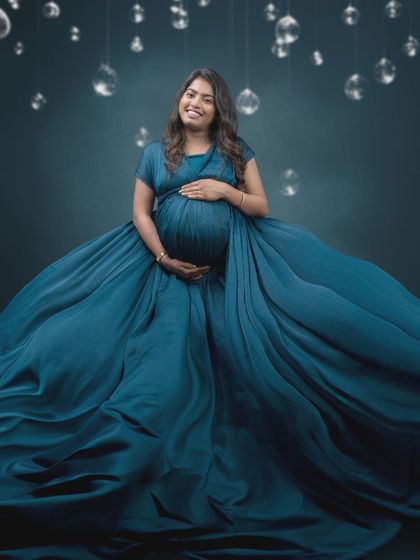 Absolutely mesmerized by this shot. The beauty of this moment is amplified by the perfect blend of art and technology, with a flowing blue gown and a dreamy backdrop.