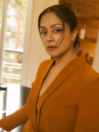 This portrait captures Jyotika's confident gaze and the clean lines of the tailored jacket.