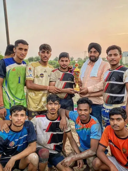 Our team celebrating their 1st position win at the Hapur 60kg kabaddi tournament on a mud court.