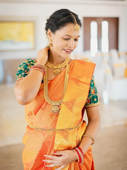 A graceful portrait of Saranya. The traditional gold jewellery adds a timeless elegance to her special day.