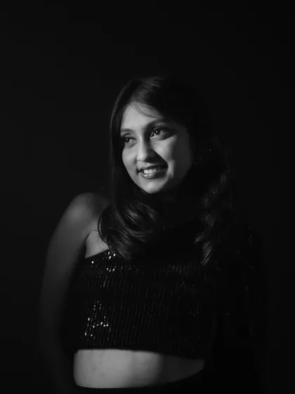 A smiling, black and white version of the portrait, giving it a timeless and classic feel.