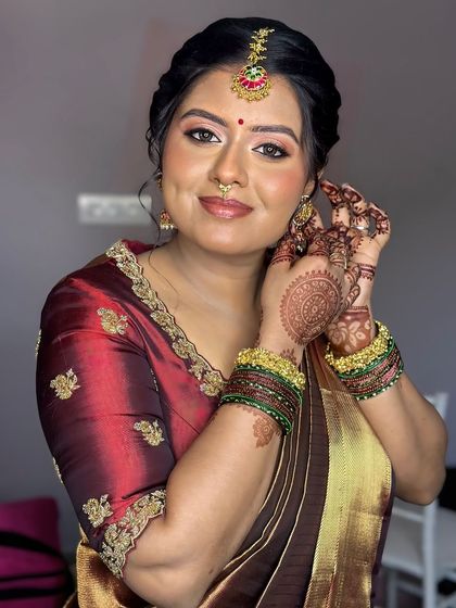 A beautiful portrait of this bride, her makeup soft and her expression serene, perfectly complementing her traditional attire.