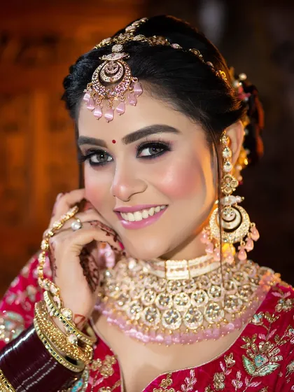 This bride is glowing in her pink and red lehenga. I used rosy tones on her cheeks and lips to create a fresh, youthful, and celebratory look.