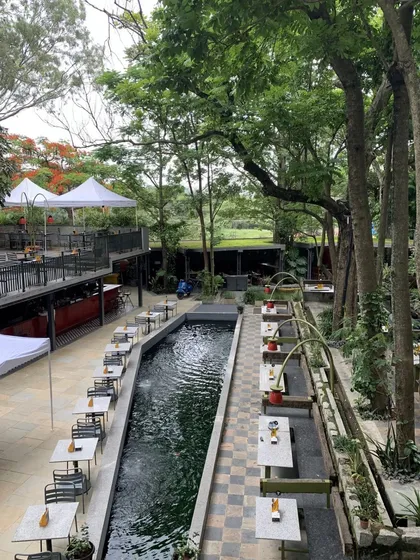 This view showcases the scale of our outdoor restaurant and its beautiful integration with the surrounding landscape and water features.