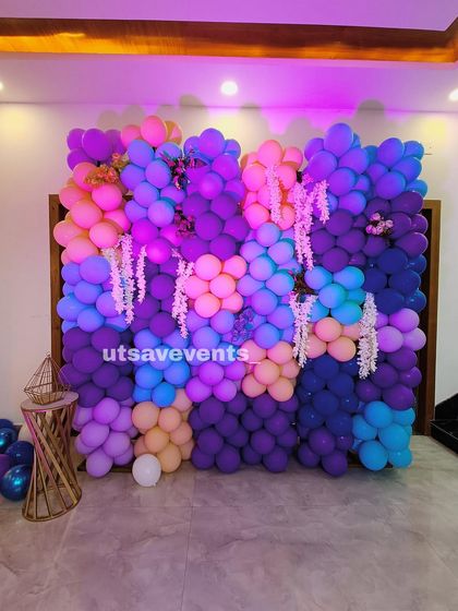 A vibrant balloon wall made of purple, blue, and pink balloons, creating a fantastic photo backdrop for any party.
