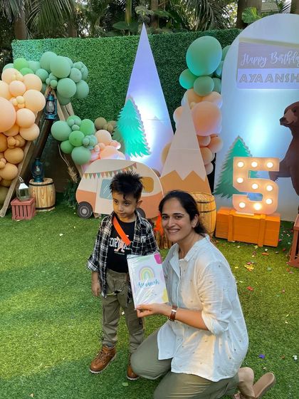 A snapshot with the birthday boy at his wild and free jungle-themed party. These little ones are so precious.