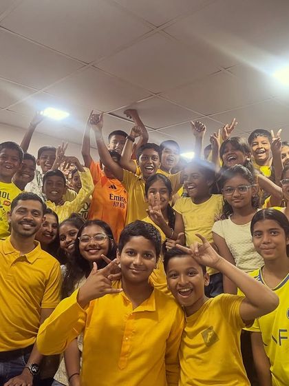 The entire class is a sea of yellow in this joyful group photo from our Navratri celebrations.