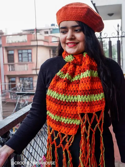 Here I am modeling a handmade crochet beret and a matching striped scarf. This shows how my winter wear is not only warm but also stylish, perfect for adding a pop of color to your cold-weather outfits.