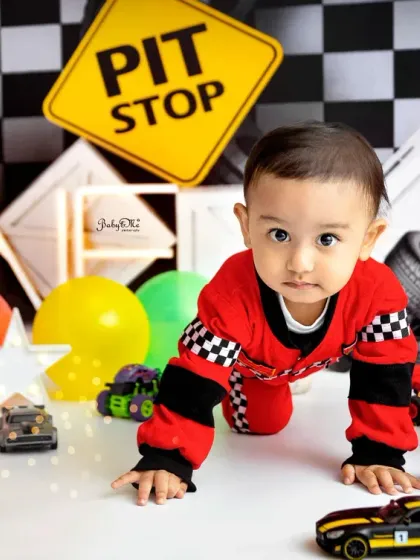 Ready to race! This crawling pose shows his excitement to explore all the little cars and props on the set.