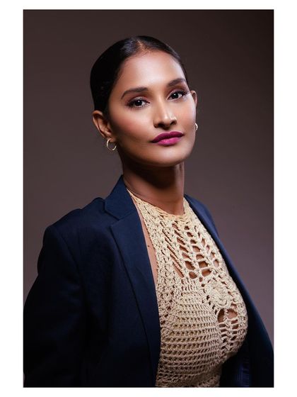 A classic portrait that showcases the entire look, including the sleek hairstyle and makeup.