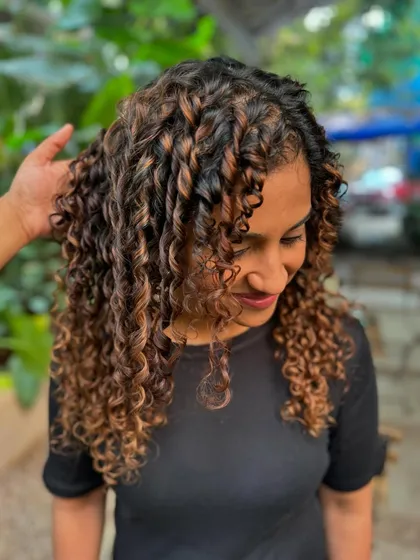 A side profile showing how the curly highlights frame the face and add dimension.